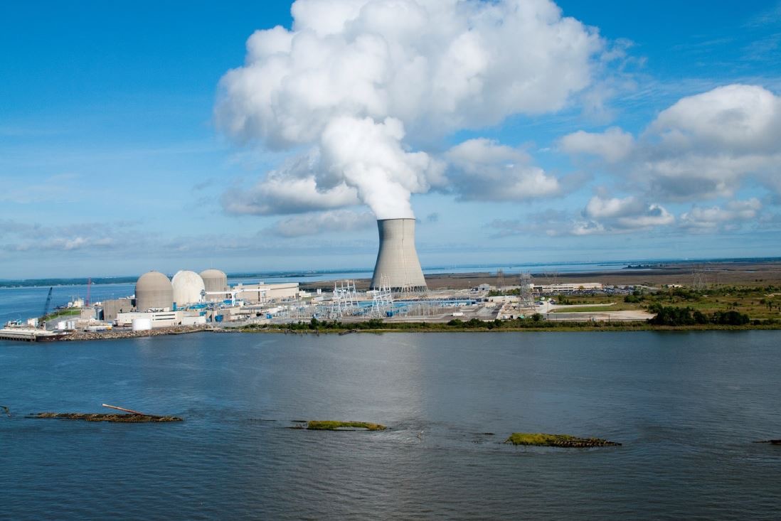 Nuclear power plant with cooling tower beside water